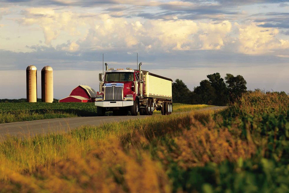 Red Western Star Truck driving on a farm field road