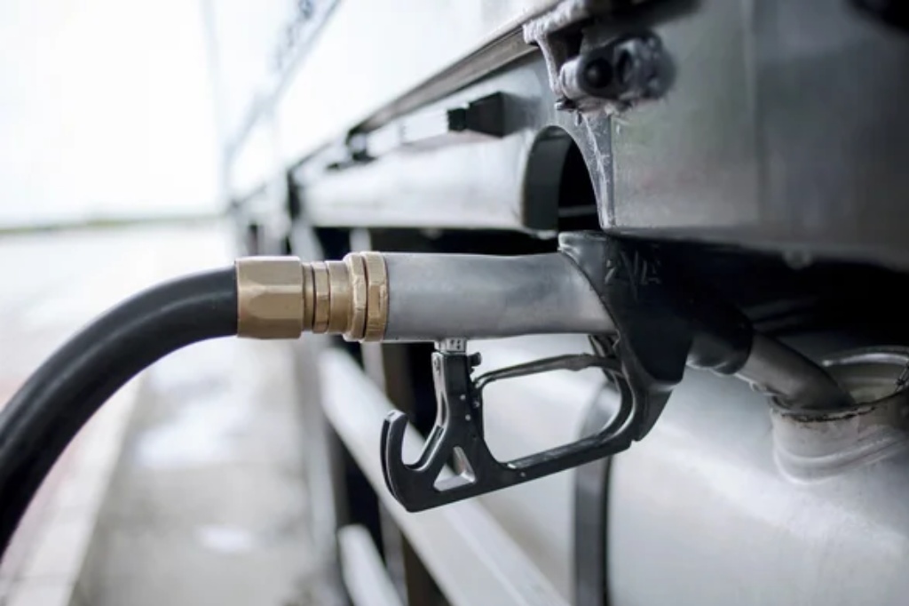 Gray fuel nozzle in pouring to truck