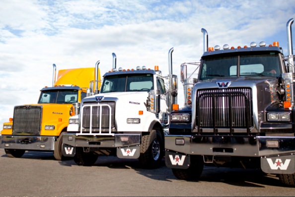 A front view of trucks that are aligned next to each other.